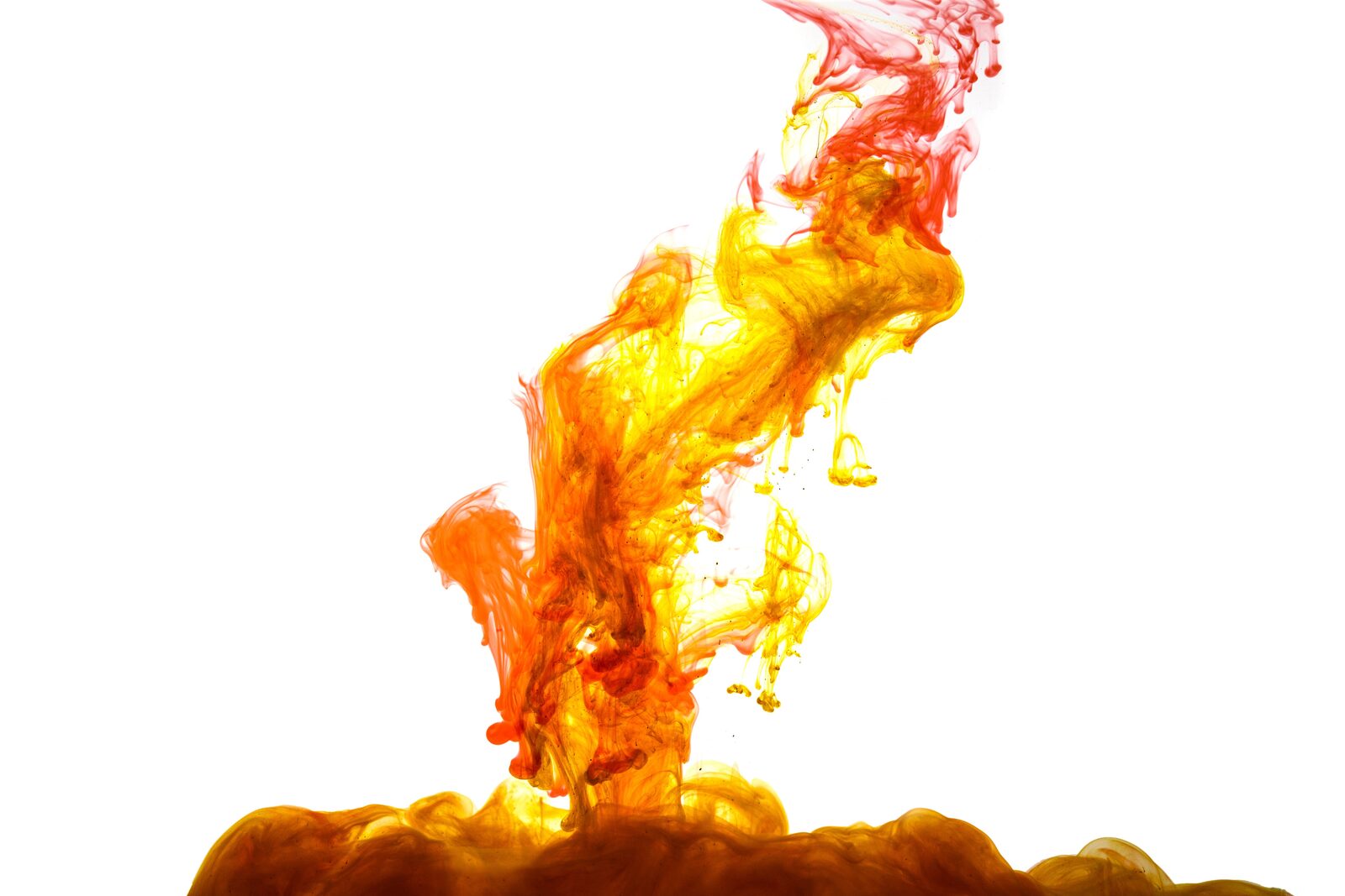 Swirling orange and red ink dispersing in water like fire against a white background